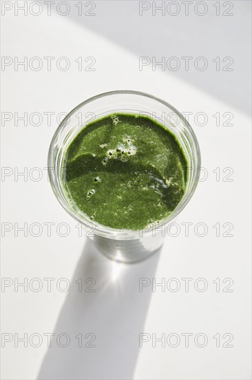 Overhead view of glass of green smoothie