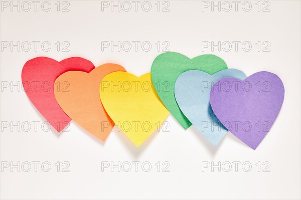 Studio shot of row of rainbow color Paper hearts