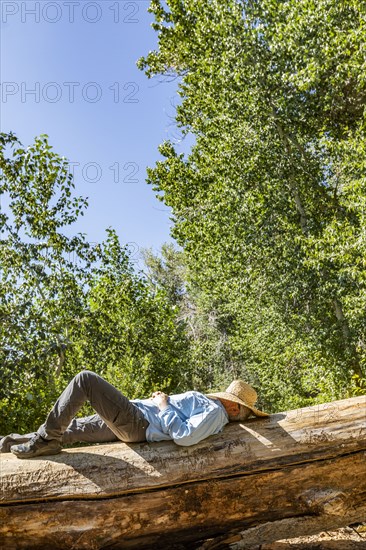 Man with straw hat on face