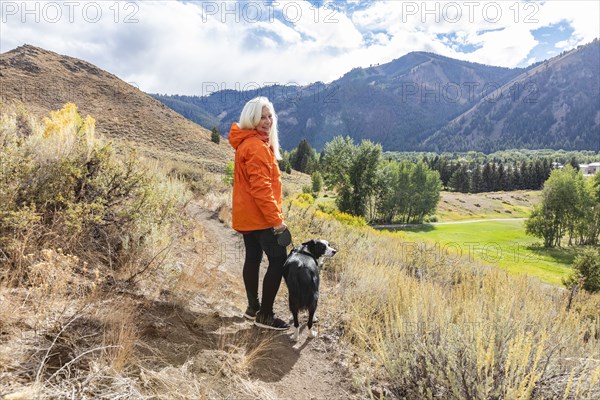 Smiling woman with border collie dog