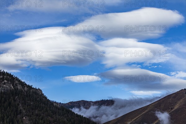 Lenticular clouds over mountains