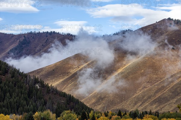 Soft clouds hanging above hills