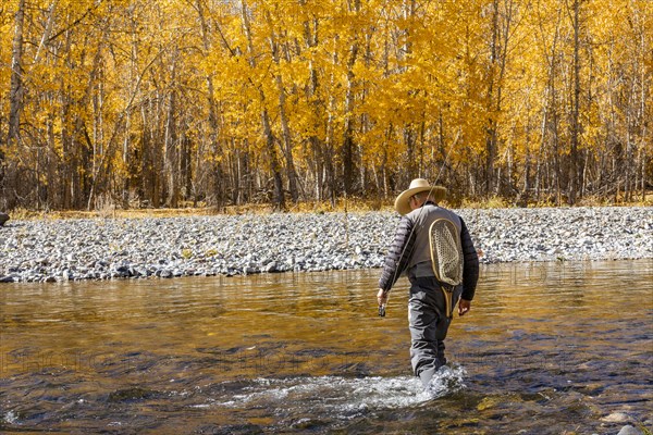 Rear view of senior fisherman