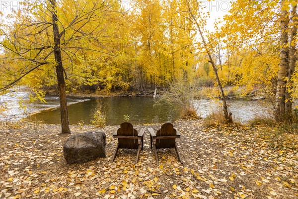 Two adirondack chairs facing Big Wood River