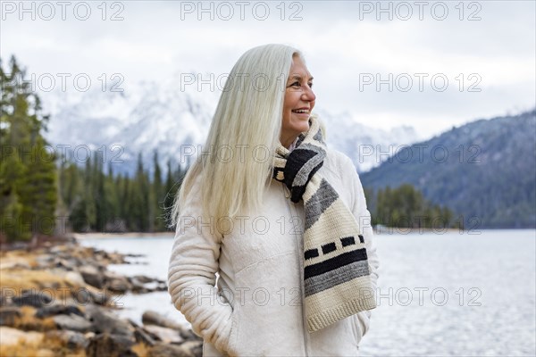 Smiling senior woman at mountain lake