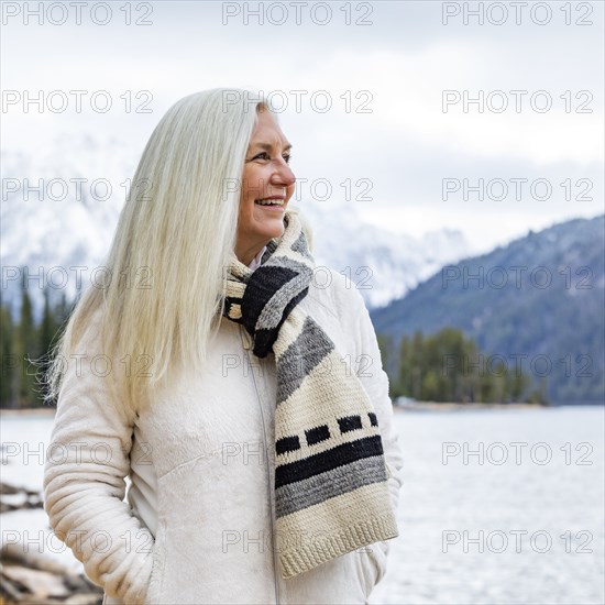 Smiling senior woman at mountain lake