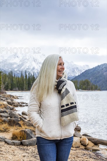 Smiling senior woman at mountain lake