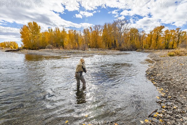 Senior woman fly-fishing