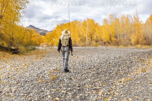 Senior woman fly-fishing