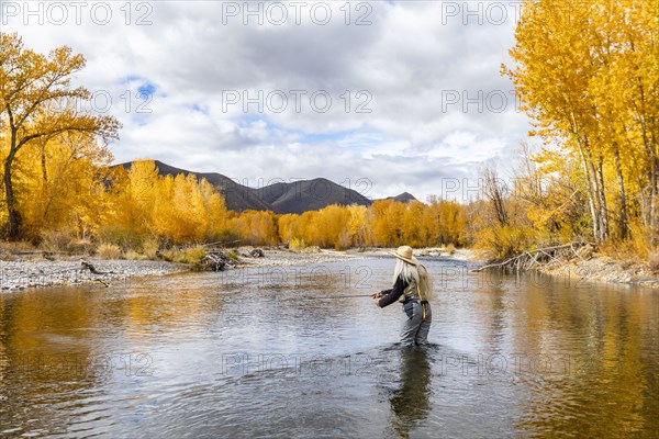 Senior woman fly-fishing