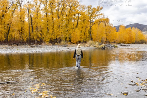 Senior woman fly-fishing