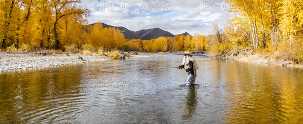 Senior woman fly-fishing