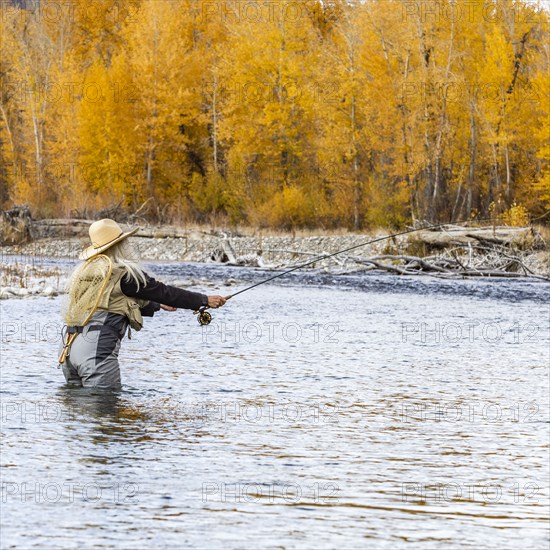 Senior woman fly-fishing