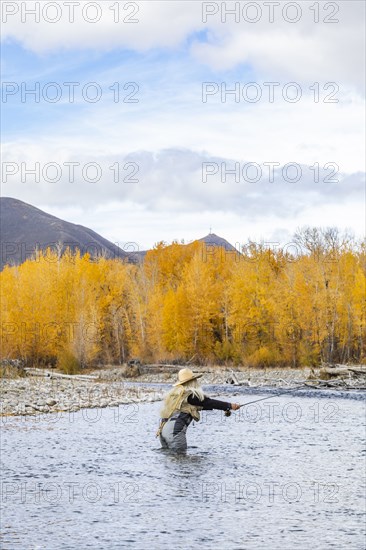 Senior woman fly-fishing