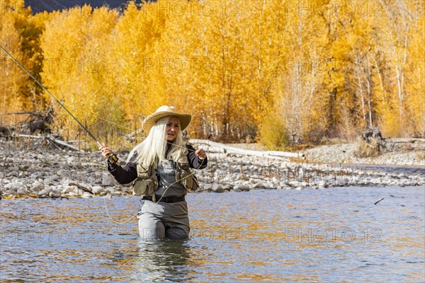 Senior woman fly-fishing