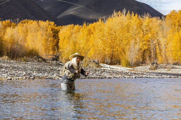 Senior woman fly-fishing