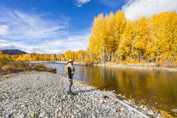 Senior woman fly-fishing