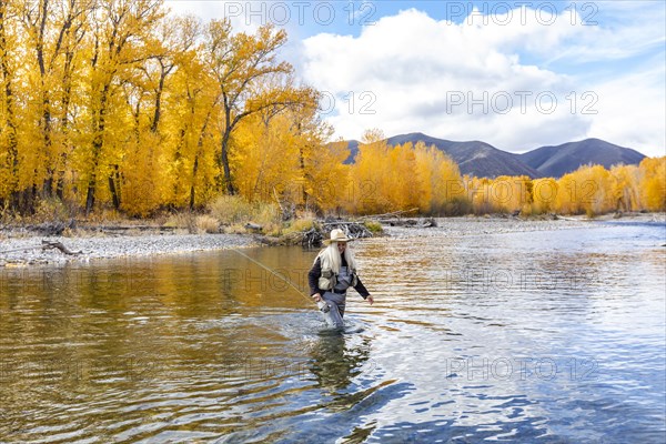 Senior woman fly-fishing