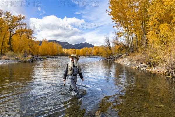 Senior woman fly-fishing