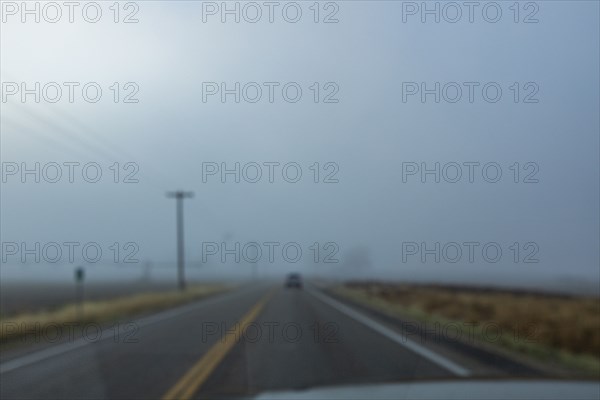 Blurred view of highway through windshield