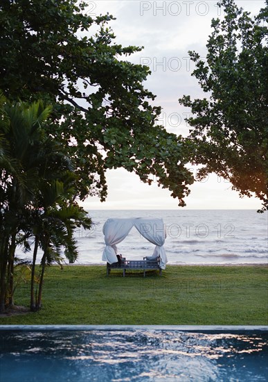 Canopy bed in hotel overlooking ocean