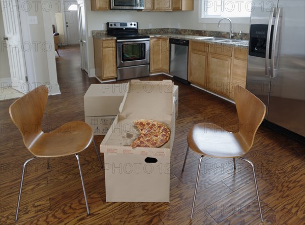 Pizza break on cardboard boxes during house move