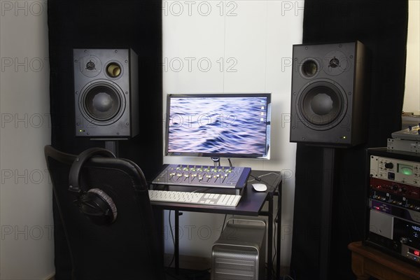 Mixing console and speakers in recording studio