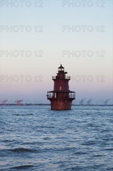 Red lighthouse in sea