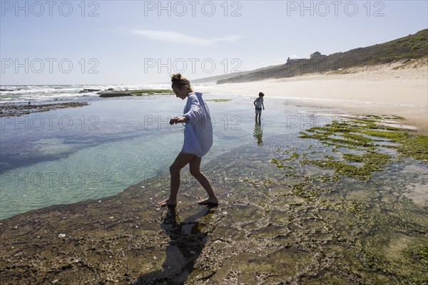 Boy and girl exploring tidal pools