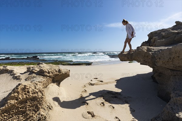 Girl balancing on rock