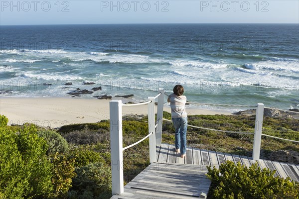 Boy looking at ocean view