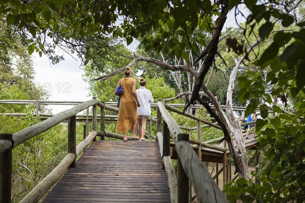 Mother and daughter on wooden walkway