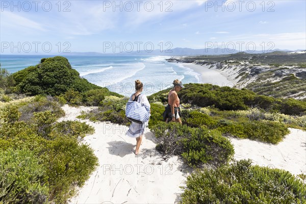 Mother and daughter exploring beach