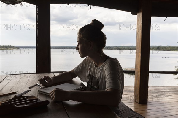 Girl relaxing in lodge by Zambezi River