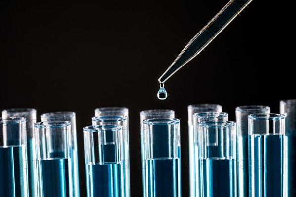 Pipette dropping liquid into test tube