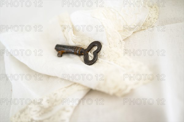 Heart shaped key on decorative white cloth