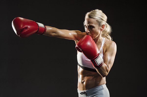 Studio shot of athlete woman boxing