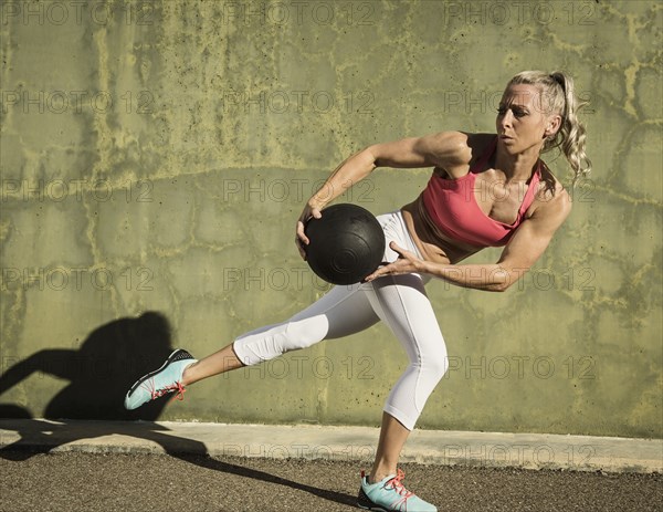 Athlete woman exercising with ball