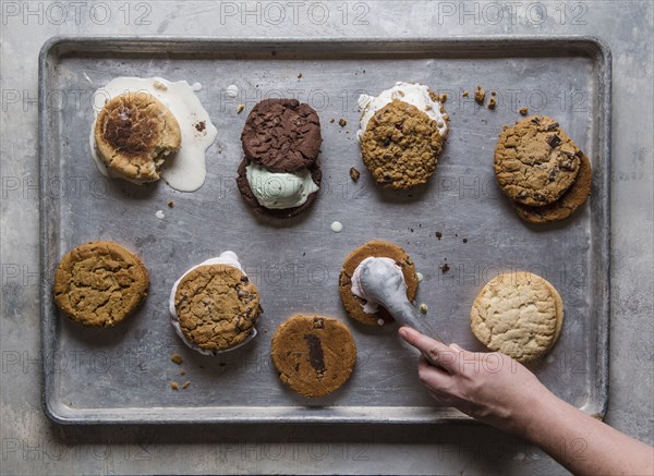 Overhead view of hand preparing ice cream sandwiches