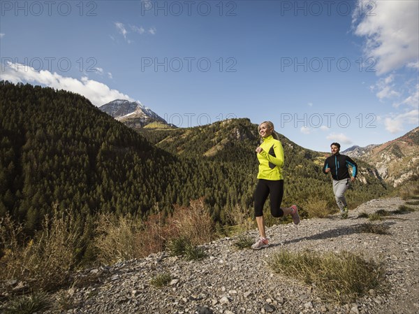 Couple jogging in mountain landscape