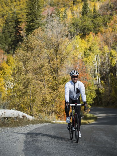 Man cycling on country road