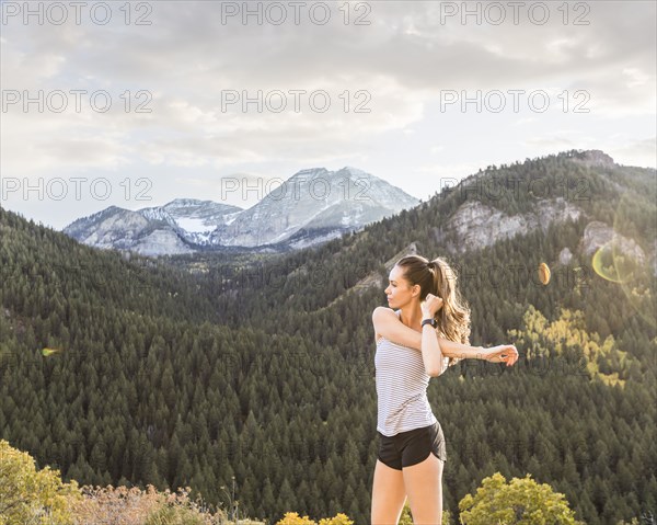 Woman stretching in mountain landscape
