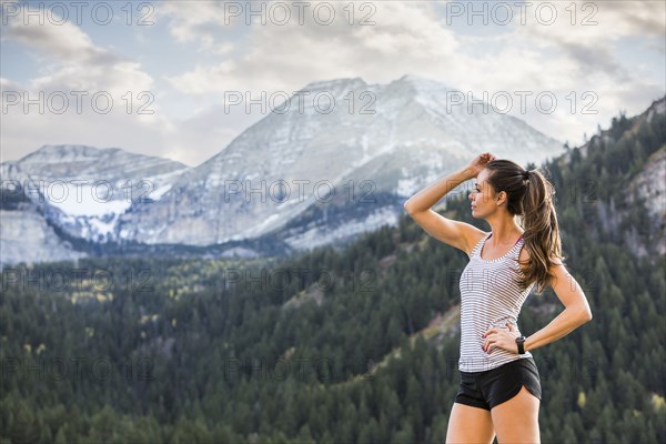 Athlete woman looking at view in mountain landscape