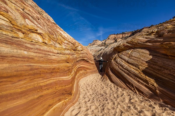 Senior hiker walking in sandstone canyon