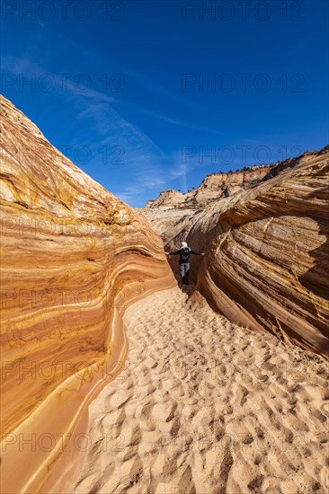 Senior hiker walking in sandstone canyon