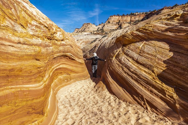 Senior hiker walking in sandstone canyon