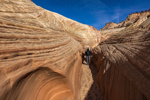 Senior hiker walking in sandstone canyon