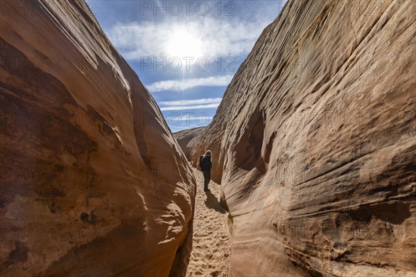 Senior hiker walking in sandstone canyon