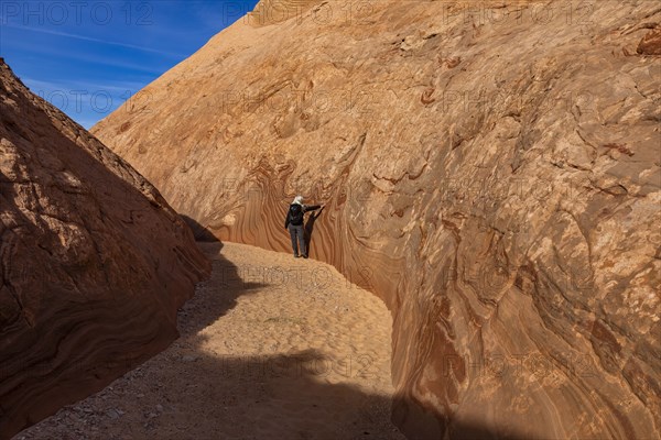 Senior hiker walking in sandstone canyon