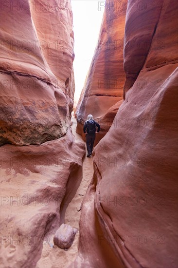 Senior hiker exploring slot canyon